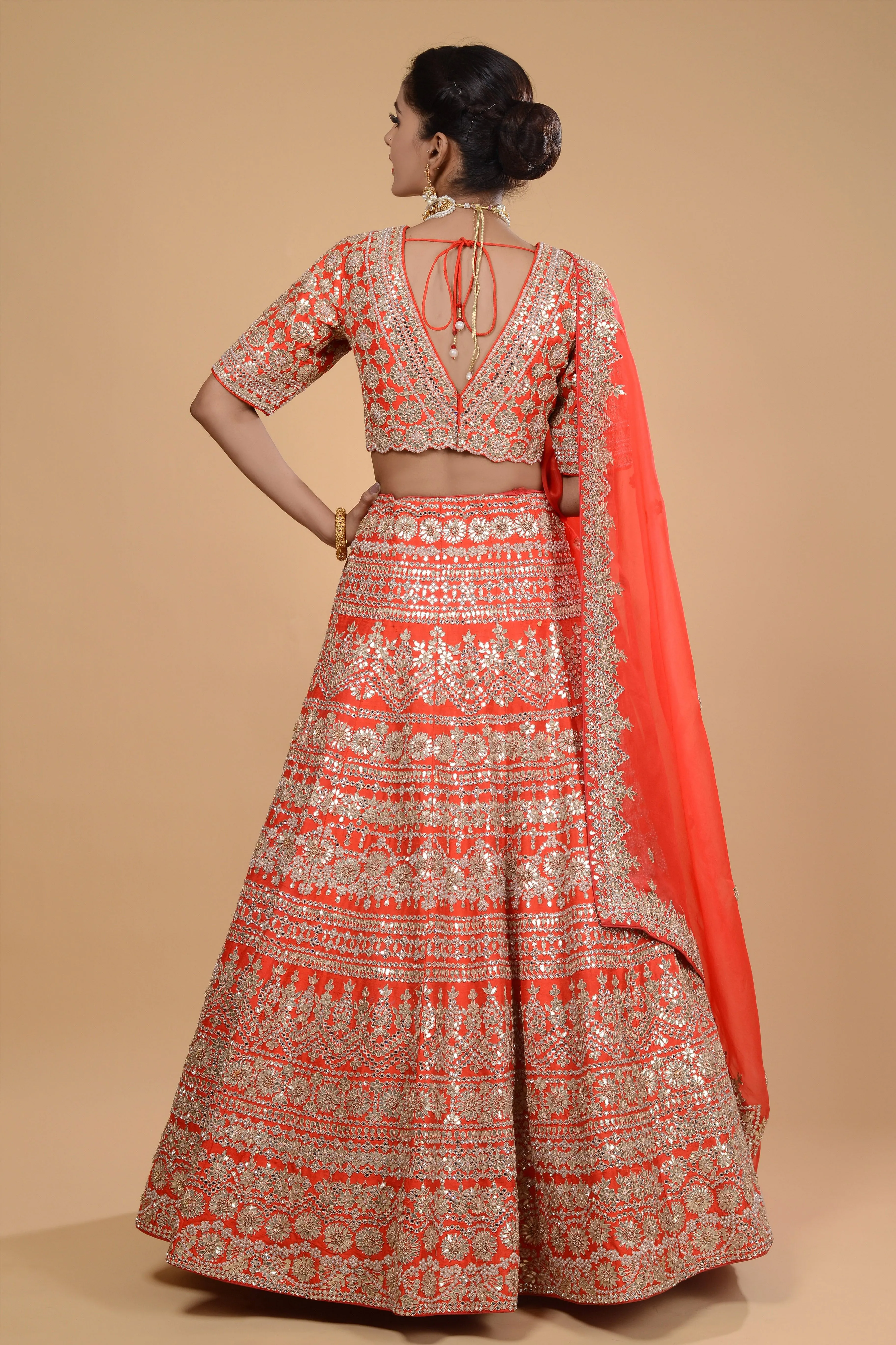 Bright Orange Embroidered Lehenga Set.